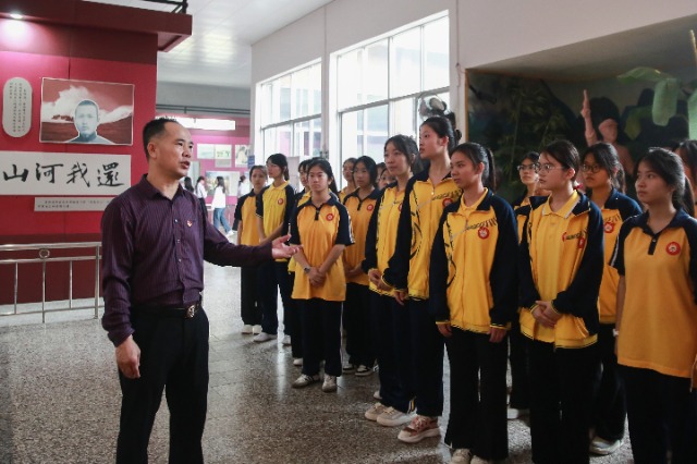 北流市明瑞高級中學黨委副書記伍華生給學生講述革命先烈的英勇事跡.jpg